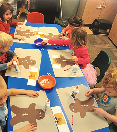 children making gingerbread men out of paper