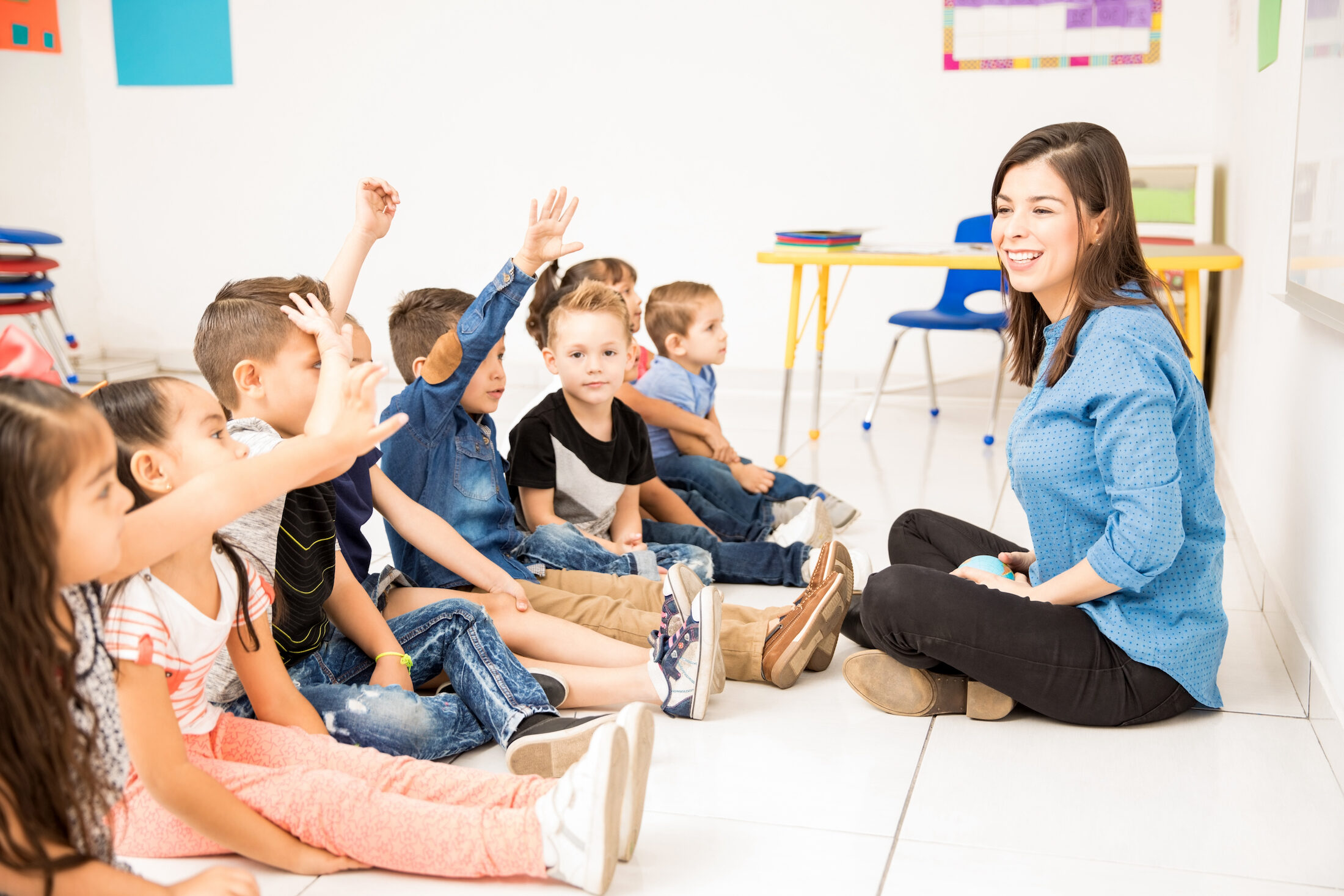 Beautiful,Preschool,Teacher,And,Her,Group,Of,Students,Raising,Their