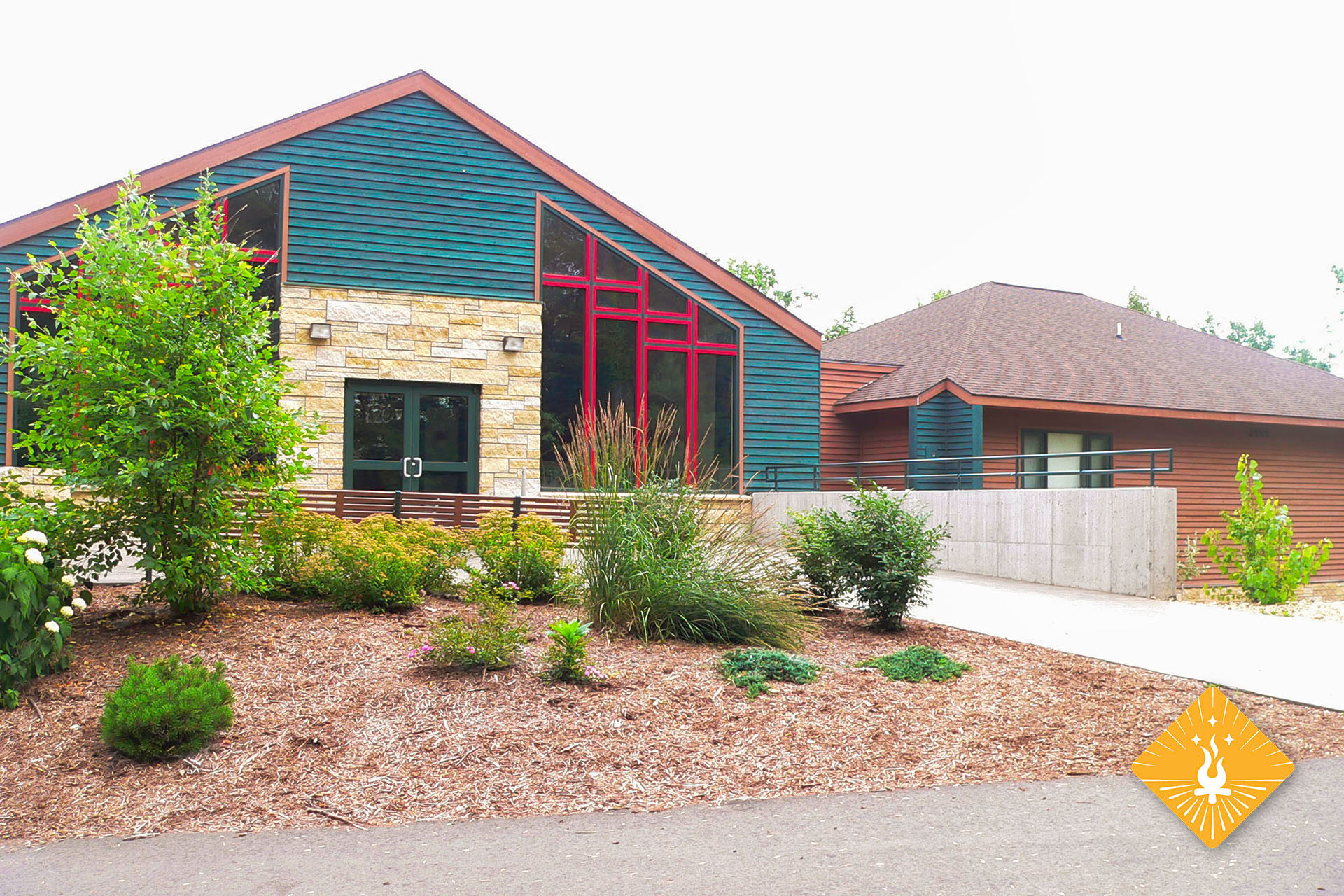 Outside view of colorful building and bushes.