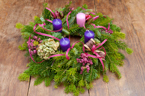 A Lutheran advent wreath with three blue candles and one purple candle.