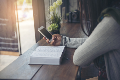 A woman uses a phone app to help with her Bible study.