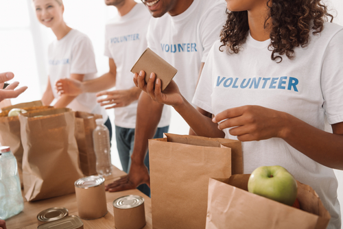 A group of volunteers packs lunches.