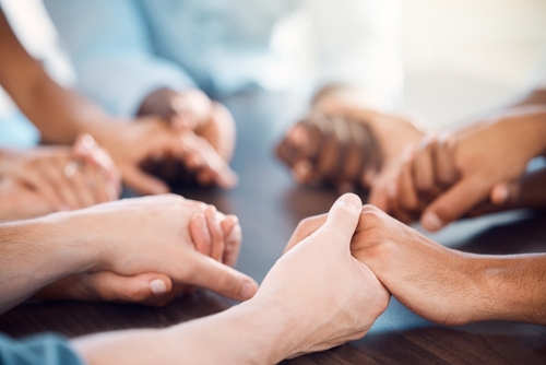 A circle of people holding hands.