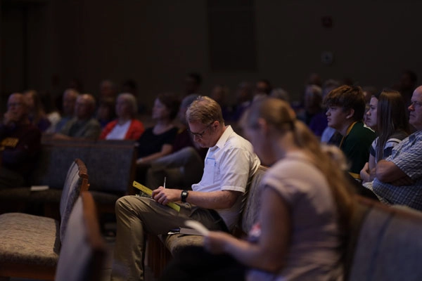 Man in pew studying bible